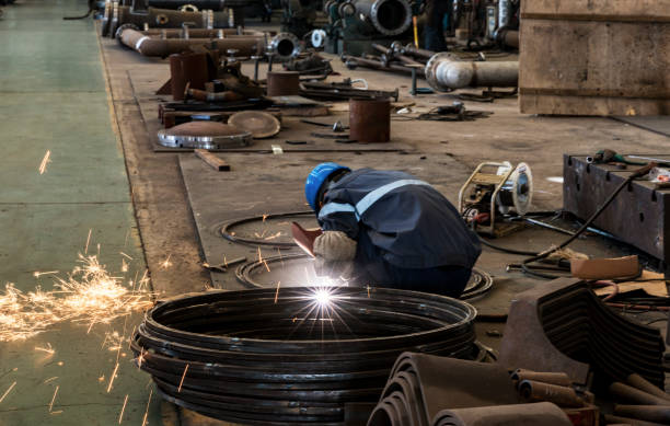 Man working at a factory of components for the thermomechanical industry.