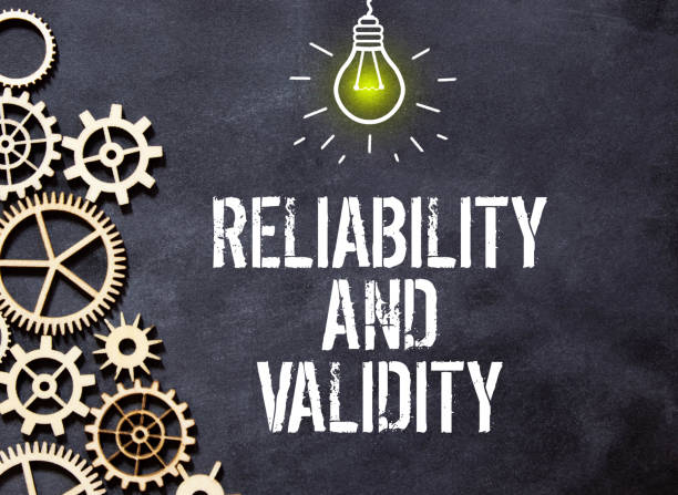 A sign with the inscription Reliability and Validity on the table with office supplies.